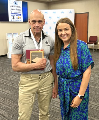 photo of the third place individual stepper, Mark, posing with Horry County Assistant Administrator Shannon Todd
