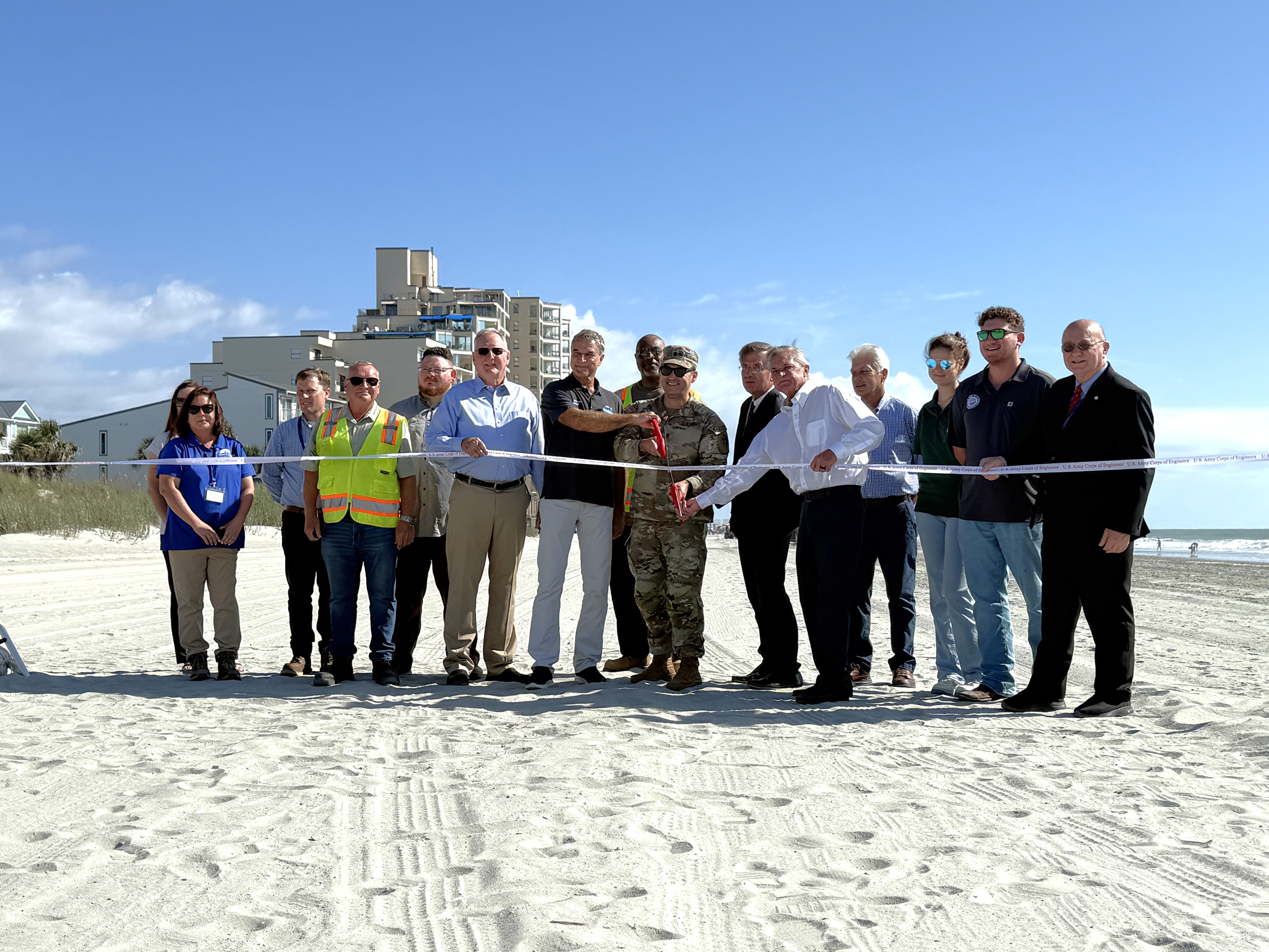 Grand Strand elected officials and employees gather for ceremonial ribbon cutting following beach renourishment project 