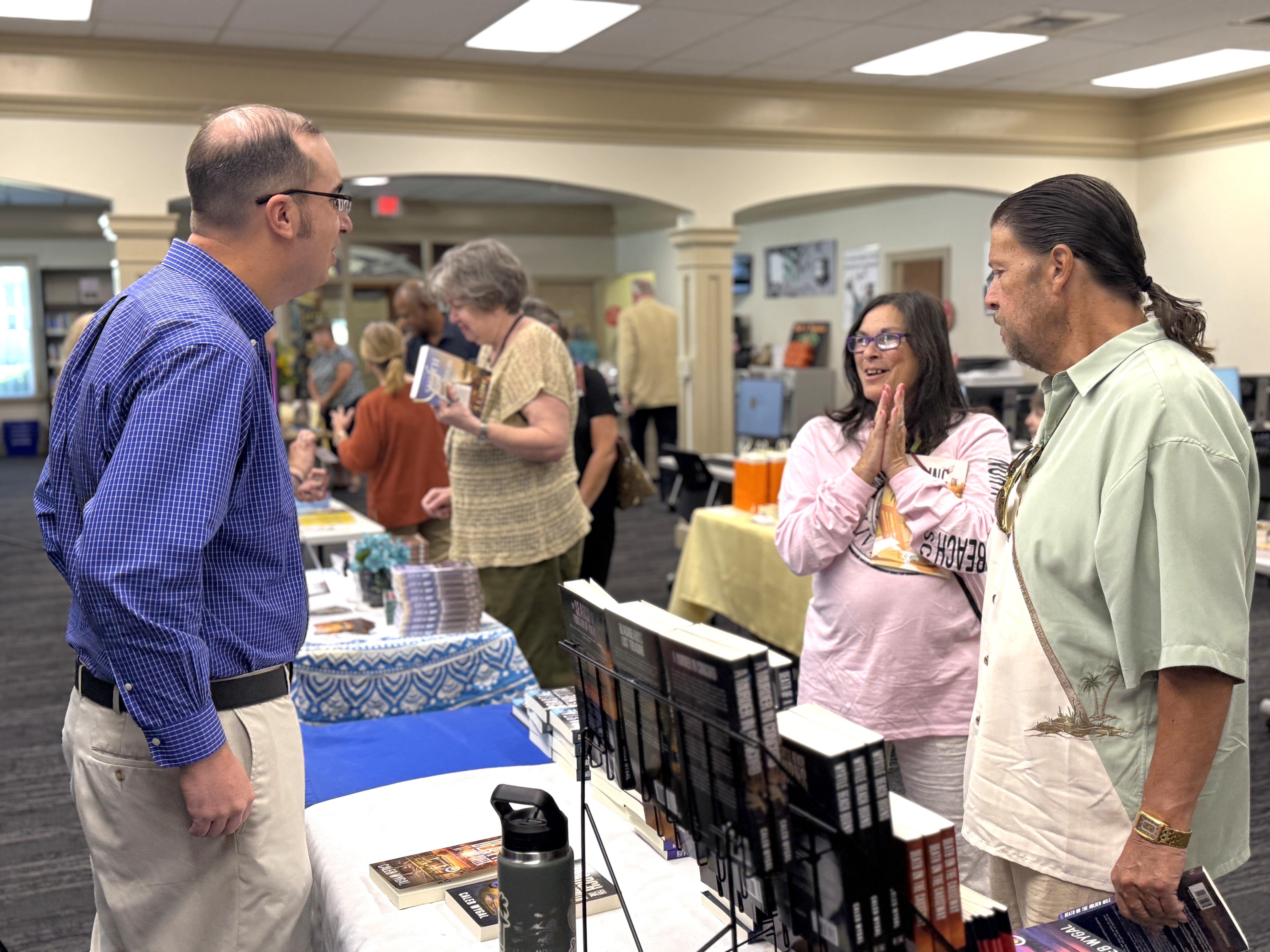 Patrons speaking with authors during 50th anniversary celebration