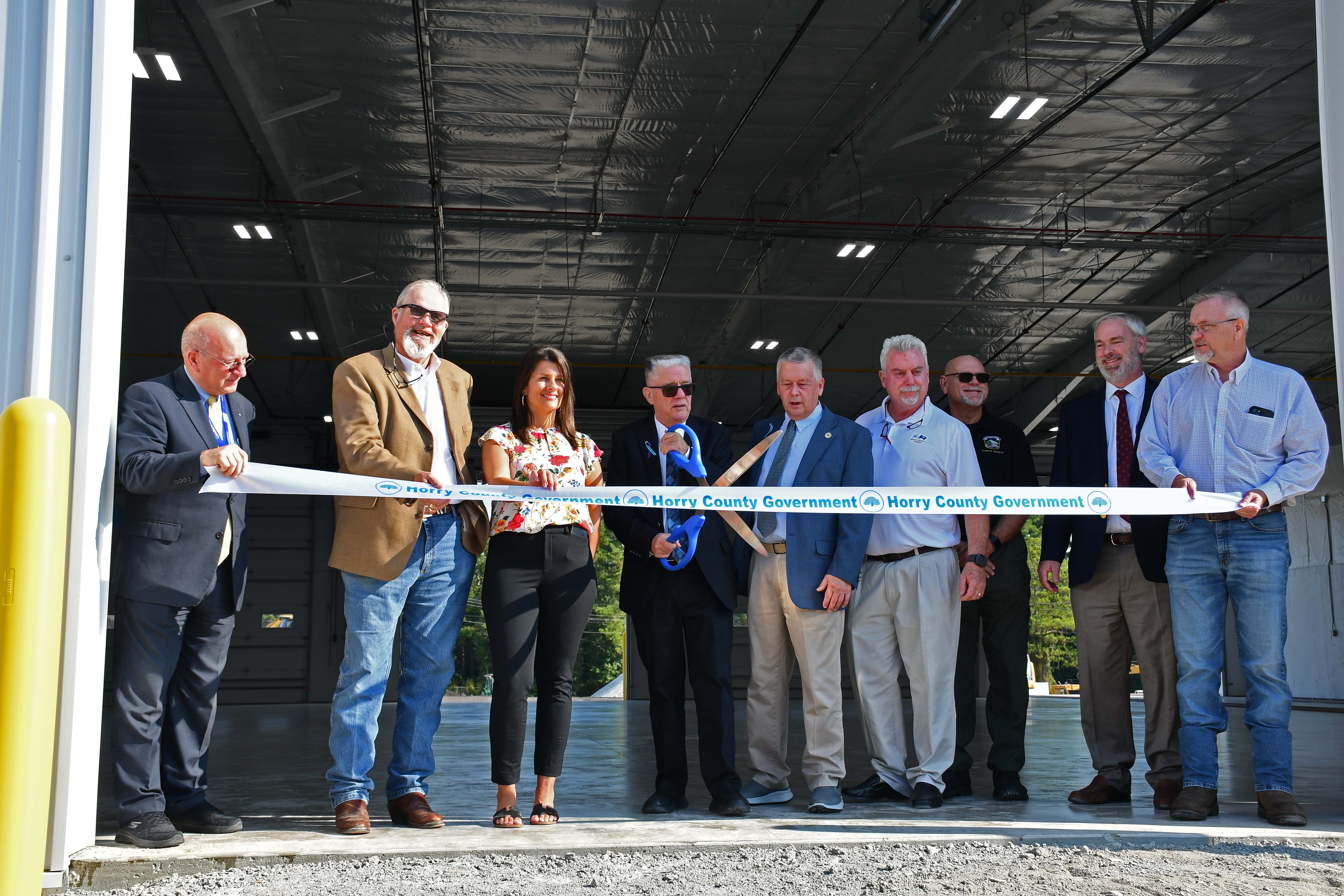 County leaders prepare to cut ribbon for the new Operations Building at the Public Works Complex